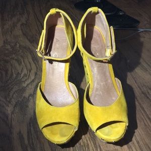 Yellow ALDO studded wedges.